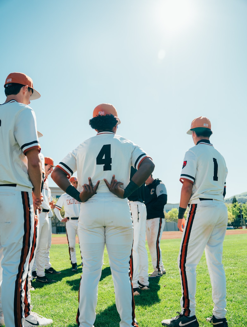 Kai Watts, #4, in the middle of a team huddle