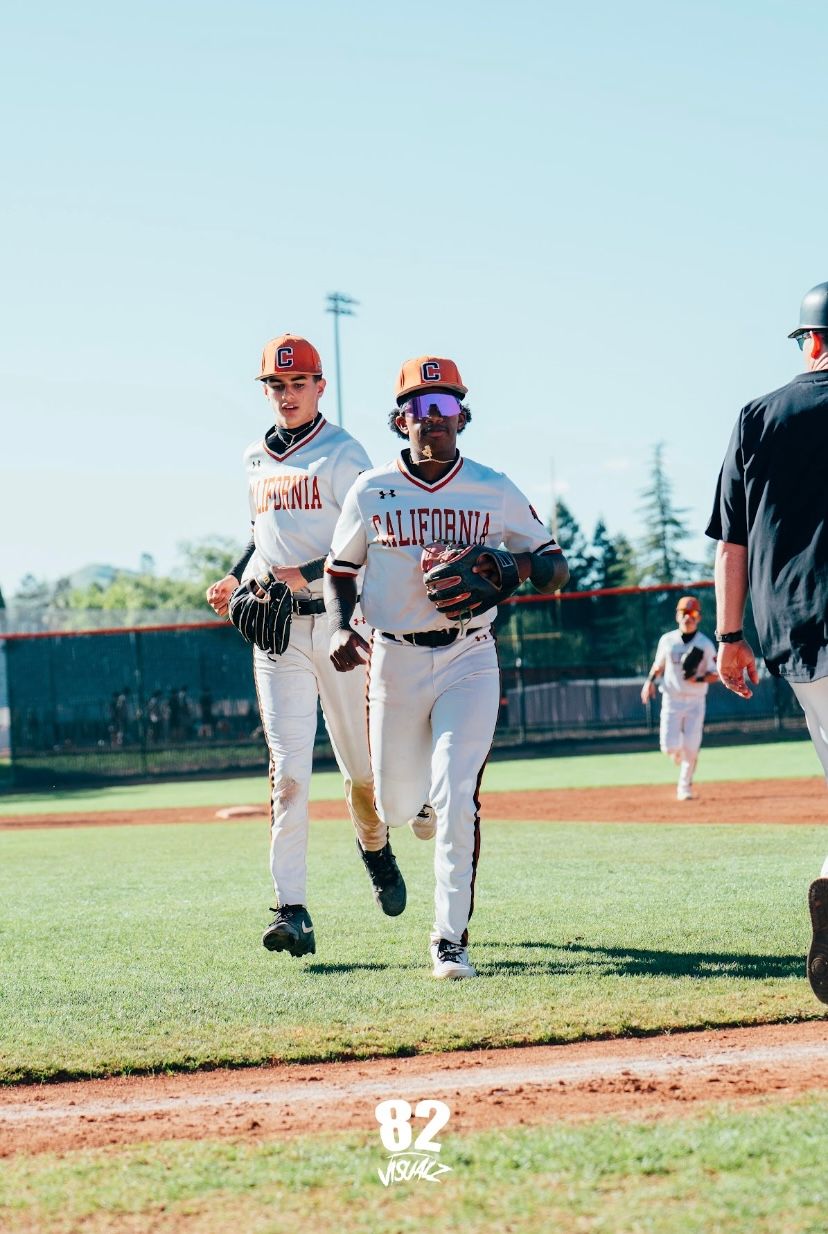 Kai Watts jogging off the field with a teammate